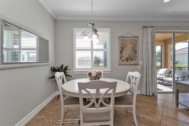 dining room featuring tile patterned floors, ornamental molding, and an inviting chandelier