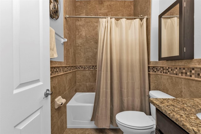 full bathroom with shower / tub combo with curtain, vanity, tile walls, and toilet