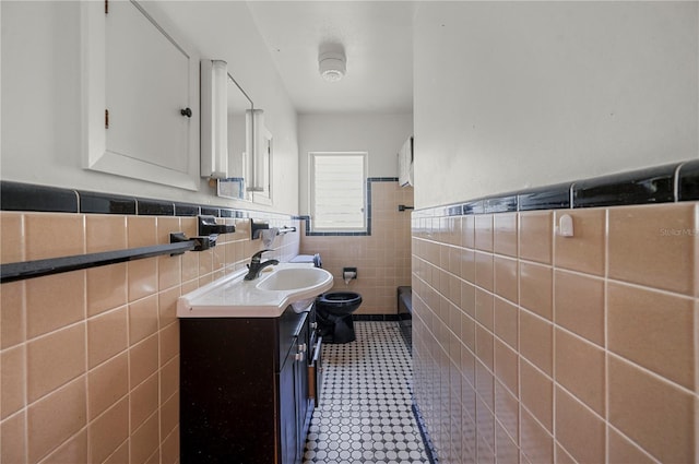 bathroom featuring toilet, tile walls, tile patterned floors, and vanity