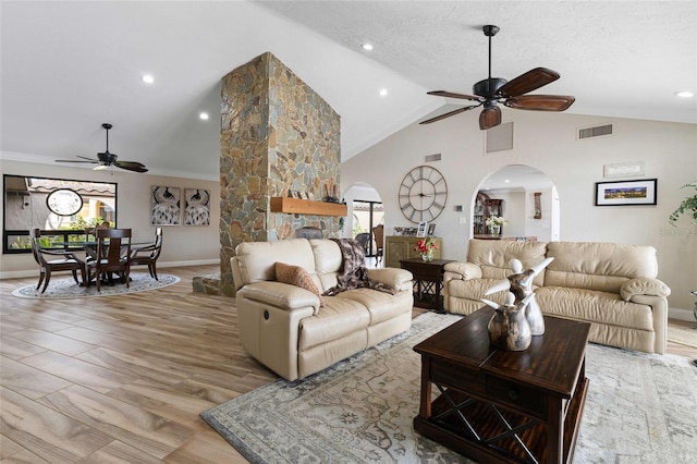 living room with ornamental molding, light hardwood / wood-style flooring, ceiling fan, and a healthy amount of sunlight