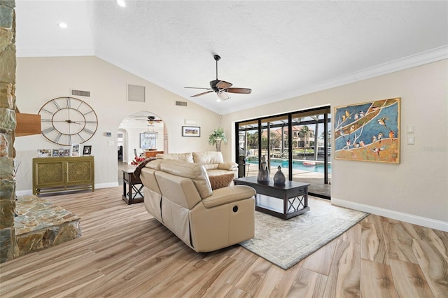 living room with ceiling fan, lofted ceiling, ornamental molding, and light hardwood / wood-style flooring