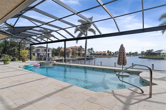 view of pool with glass enclosure, a patio area, and a water view