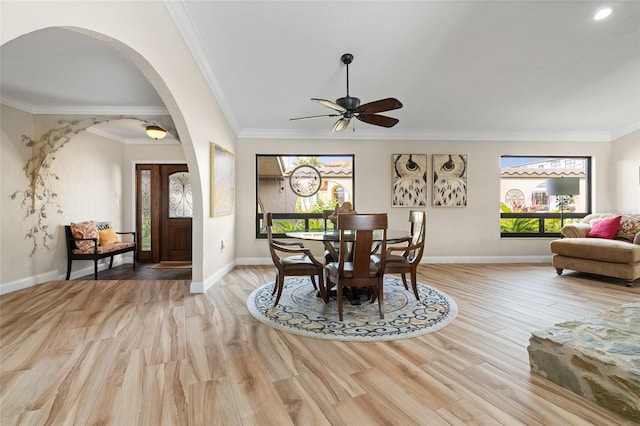 dining room featuring light wood-type flooring, ceiling fan, and ornamental molding