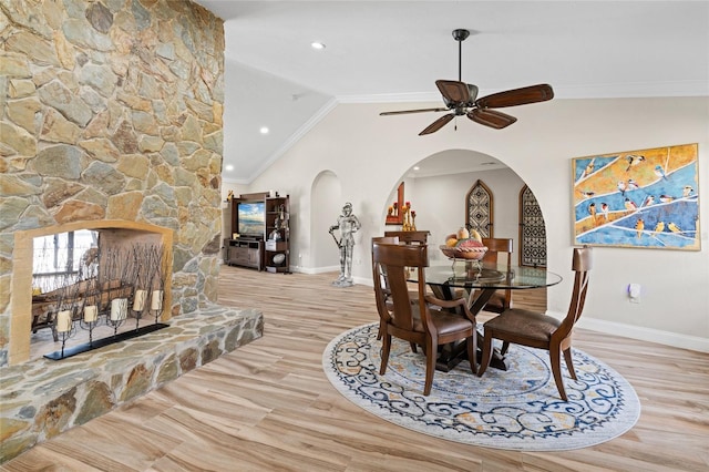 dining space with light hardwood / wood-style floors, vaulted ceiling, ceiling fan, and crown molding