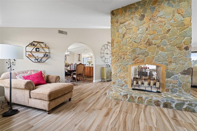 living room featuring wood-type flooring and crown molding