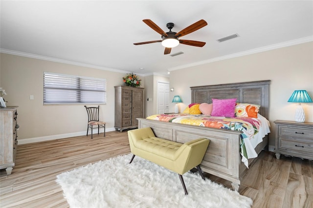 bedroom featuring ceiling fan, light wood-type flooring, and crown molding