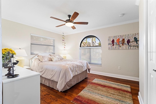 bedroom with dark hardwood / wood-style flooring, ceiling fan, and crown molding