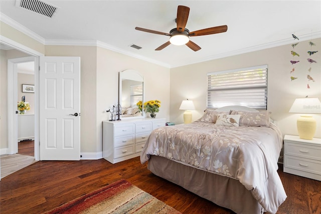 bedroom featuring ceiling fan, ornamental molding, and dark wood-type flooring