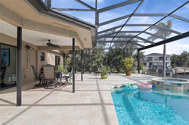 view of swimming pool featuring an in ground hot tub, a patio, ceiling fan, and a lanai