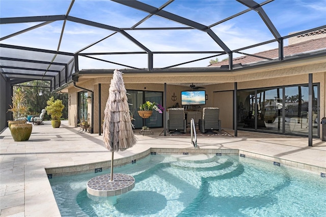 view of swimming pool with a patio area, ceiling fan, and a lanai