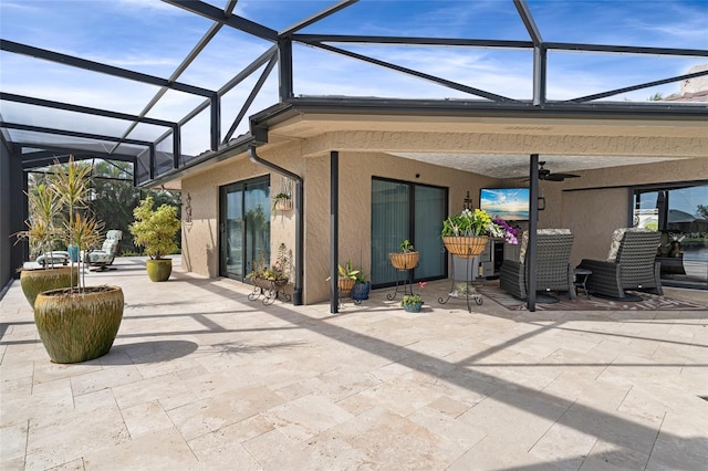 view of patio featuring glass enclosure and ceiling fan