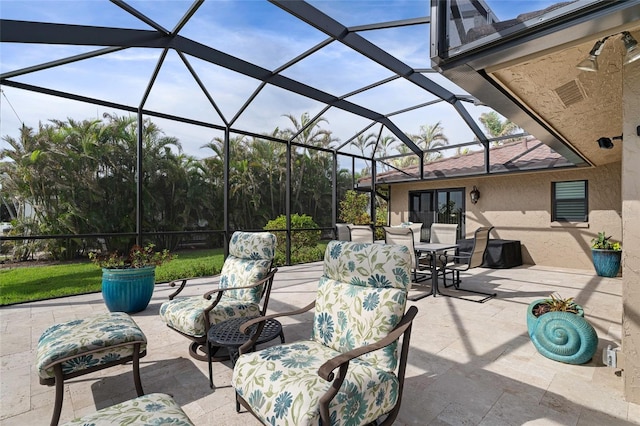 view of patio / terrace featuring a lanai