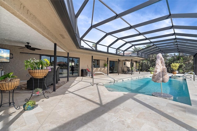 view of pool featuring ceiling fan, a patio area, and a lanai