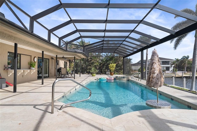 view of pool featuring a patio, a water view, ceiling fan, and a lanai