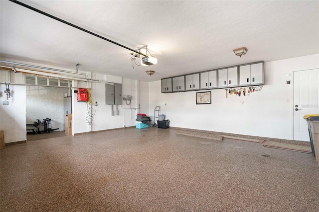 garage featuring electric panel and a garage door opener