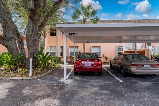 view of parking / parking lot featuring a carport