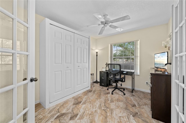 office featuring a textured ceiling, ceiling fan, and french doors