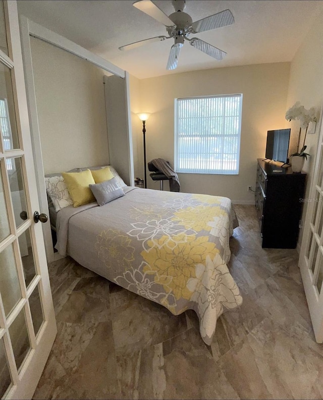 bedroom featuring french doors and ceiling fan