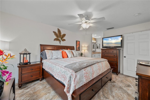 bedroom with ensuite bathroom and ceiling fan