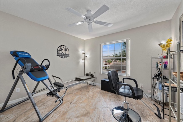 exercise area featuring a textured ceiling and ceiling fan