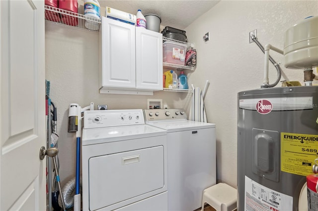 clothes washing area featuring washer and dryer, cabinets, electric water heater, and a textured ceiling