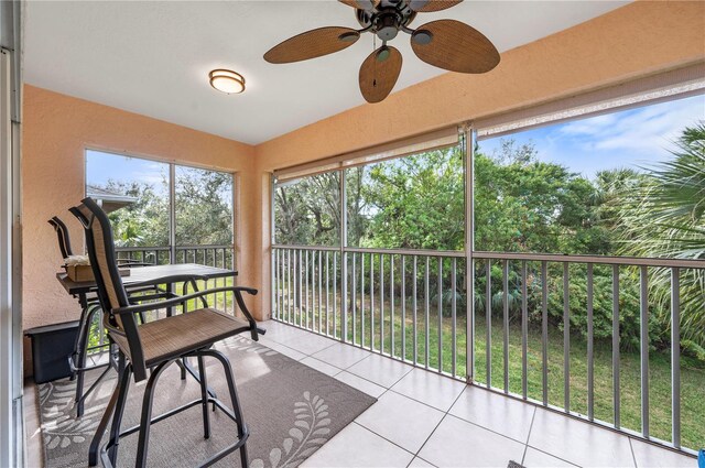 sunroom / solarium featuring ceiling fan