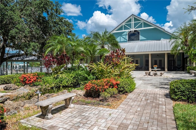 back of house featuring ceiling fan and a patio