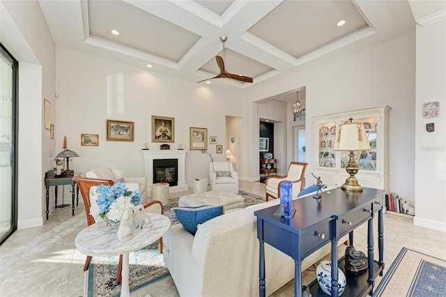 living room featuring beamed ceiling, a high ceiling, ceiling fan, and coffered ceiling