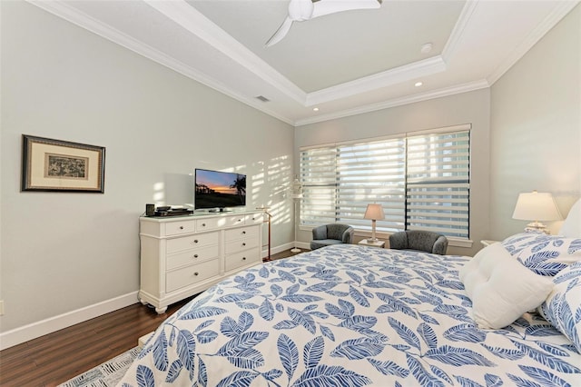 bedroom with ceiling fan, dark hardwood / wood-style floors, crown molding, and a tray ceiling