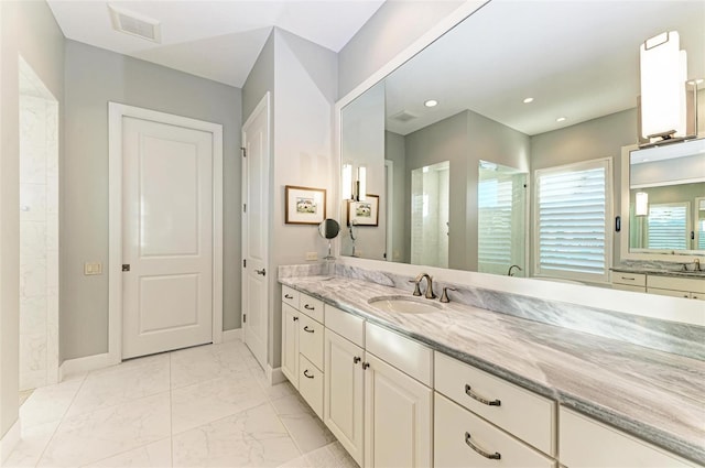 bathroom with a shower and vanity