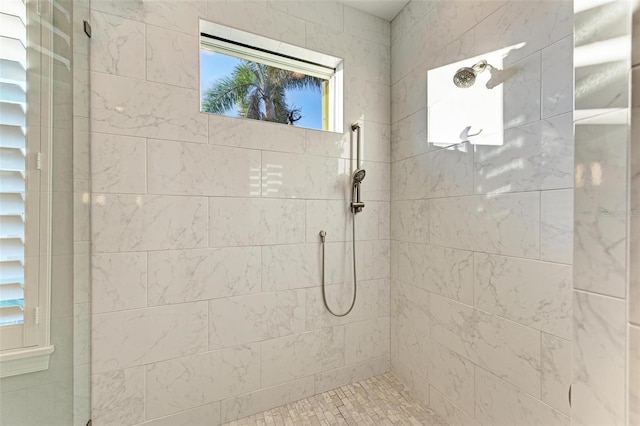 bathroom with a tile shower