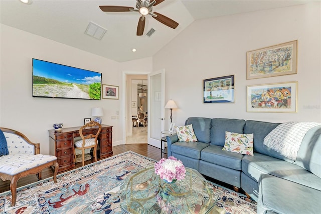 living room with ceiling fan, lofted ceiling, and hardwood / wood-style flooring