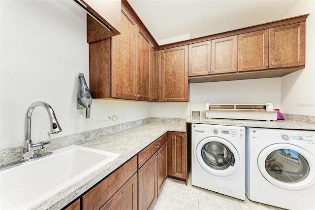 washroom featuring sink, light tile patterned floors, cabinets, and independent washer and dryer