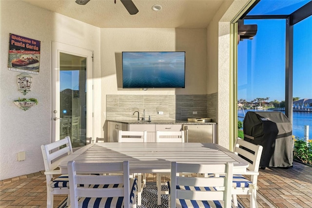 view of patio / terrace with a lanai, a grill, and ceiling fan