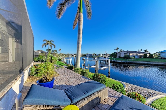 view of patio with a boat dock and a water view