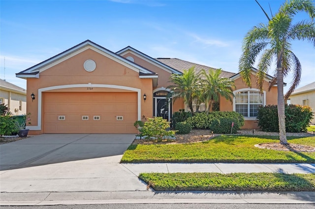 ranch-style home with a garage and a front lawn