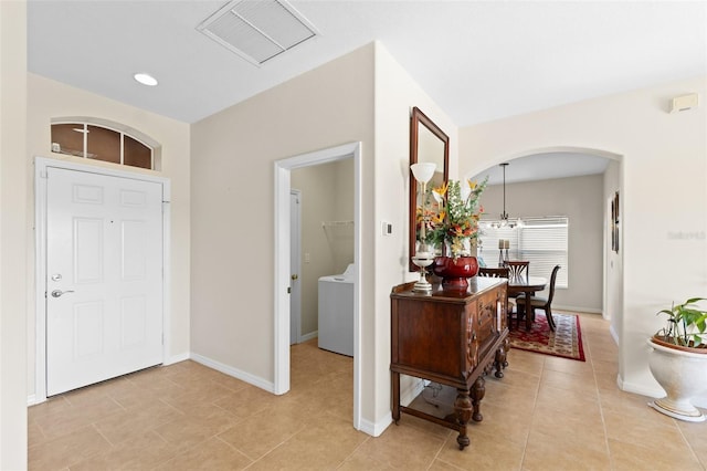 tiled foyer featuring washer / dryer