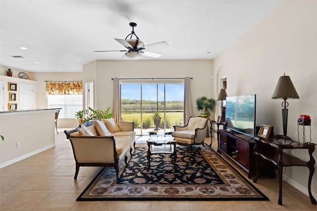 living room with ceiling fan and light tile patterned floors