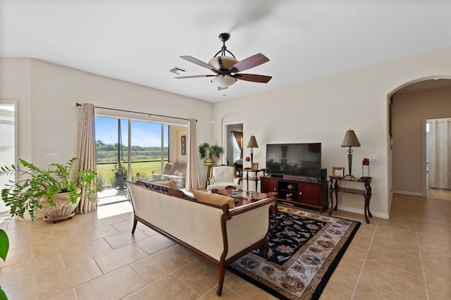 living room with light tile patterned floors and ceiling fan