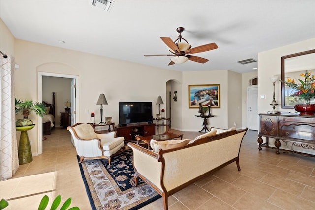 living room featuring light tile patterned floors and ceiling fan