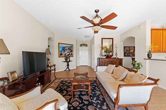 living room with ceiling fan and light tile patterned floors