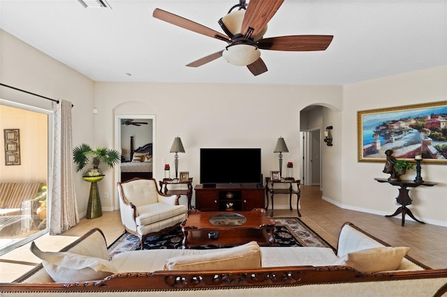 living room featuring tile patterned floors and ceiling fan