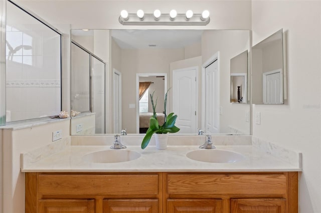 bathroom featuring vanity and an enclosed shower