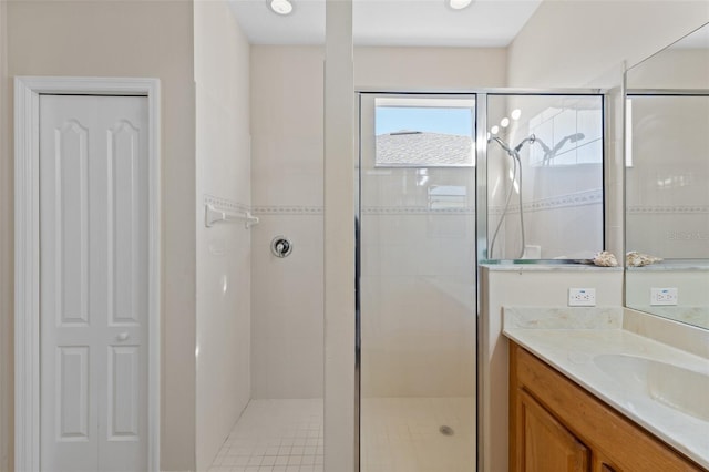 bathroom with vanity and a shower with shower door