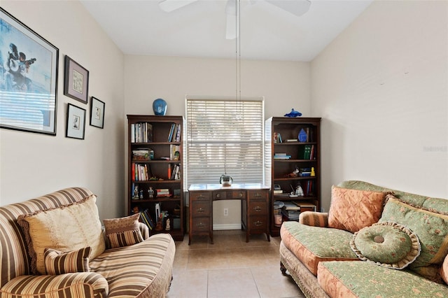 living area with ceiling fan and light tile patterned floors