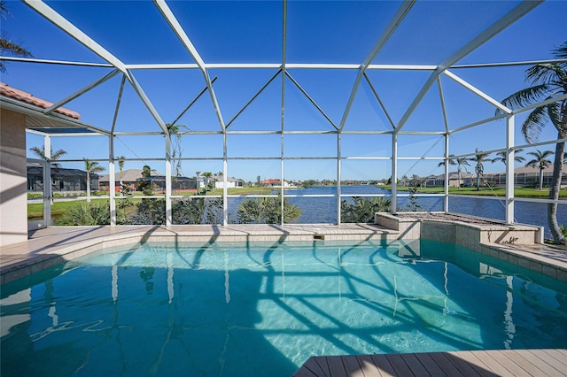 view of pool featuring glass enclosure and a water view