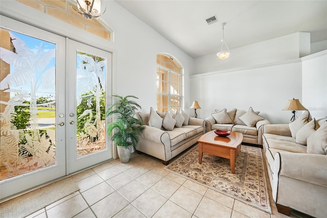 tiled living room with french doors, vaulted ceiling, and a healthy amount of sunlight