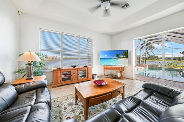 living room featuring ceiling fan, plenty of natural light, and light tile patterned floors