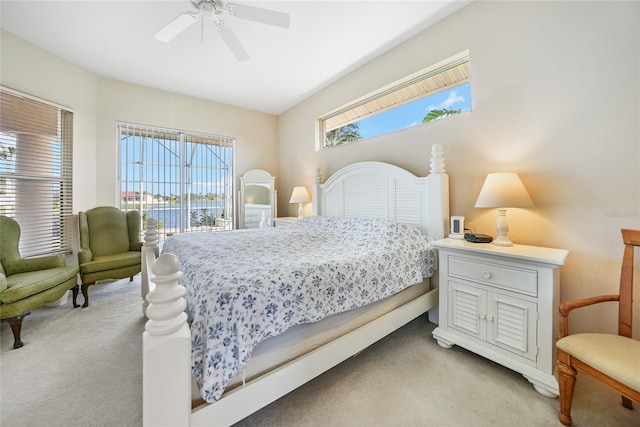 carpeted bedroom with access to outside and ceiling fan