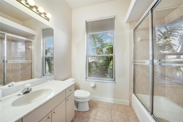 full bathroom with tile patterned floors, vanity, toilet, and enclosed tub / shower combo